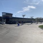 Cars are lined up at Oasis car wash on a beautiful day